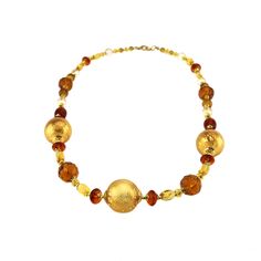 The talents of the Murano Glass Masters are brought to life in this hand blown glass bead necklace.  This exquisite necklace, 27" length, offers a stunning display of design with a combination of amber and gold glass beads.  Combining the perfect mix of traditional Murano Glass elegance and modern styled jewelry design creates an elegant addition to any jewelry collection.  Each necklace is ready to ship in a gold jewelry gift box tied with a gold cord.  A Murano Glass Certificate of Authenticity is included with each piece.  A Murano Glass Necklace is the perfect gift idea for her for any occasion such as Birthdays, Anniversaries, Valentine's Day and Mother's Day.  Gift messaging available. It's also the special final touch to complement any outfit.  As each necklace is individually hand Adjustable Murano Glass Necklace, Large Gold Beads For Costume Jewelry, Adjustable Gold Beaded Necklace With Large Beads, Adjustable Gold Beaded Necklaces With Large Beads, Adjustable Round Murano Glass Necklace, Brown Glass Beads For Jewelry Making, Elegant Orange Czech Glass Jewelry, Single Strand Glass Spiritual Necklace, Elegant Amber Necklace With Gold Beads