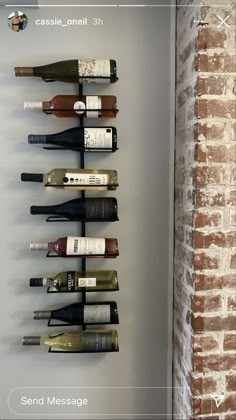 a wall mounted wine rack with several bottles on it and the words send message below