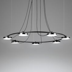 a circular chandelier with five lights hanging from it