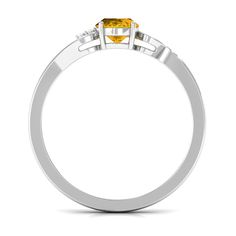 a yellow diamond ring with two white diamonds on the sides and an orange stone in the middle