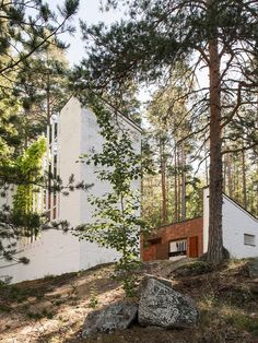 the house is surrounded by trees and rocks