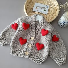 "HeartMotifKnittedCardigan, LoveBabyClothes, Heart BabyGift, BabyhandmadeCardigan, BabyGirlGift, HandmadeSweater 🧶GENERAL FEATURES🧶 As CottonBabiesknitBoutiques, I've designed a Heart Motif cardigan to accompany your special days with your baby. You can crow your most special moments with the most special cardigan. Whether for baby photoshoot concepts, birthdays, or as handmade gift, you can delight your loved ones with this knitted cardigan. We prepare and ship your orders within 5-7 days. The design of the cardigan belongs to me. You can choose it for both boys and girls. You can send me a message for color preference and size preference. It does not contain chemical materials that may affect human health. For long-lasting use of both our summer and winter varieties, we recommend that Cute Fall Cardigan For Playtime, Cute Long Sleeve Cardigan For Playtime, Cute Warm Knit Sweater, Cozy Knitted Sweater For Playtime, Cozy Knitted Sweater For Casual Wear, Handmade Sweater As Winter Gift, Cute Knit Sweater For Playtime, Cute Winter Sweater As A Gift, Handmade Sweater Winter Gift