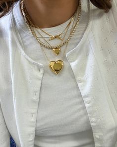 The Cora Heart Necklace is the perfect accessory for those who love bold, fun jewelry. It has a puffy golden heart design and's perfect for layering with other pieces. Plus, its water-resistant material ensures it will look great for years. 16" length plus 2" extender Small .5" width Golden Heart Necklace, Levis Outfit, Herringbone Necklace, Hair Perfume, Wardrobe Accessories, Golden Heart, Clothes Wishlist, Gold Heart Necklace, Fun Jewelry