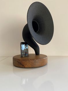 a speaker and cell phone on a stand