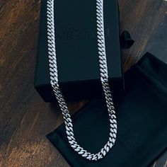 Showcase your impeccable taste, and let the Crescent Chain become your own signature accessory. Inspired by classic and original motifs, the smooth curves of polished links add a modern twist to this sleek chain, allowing for an easy, comfortable wear all day long. Crescent Link Chain Necklace Chain Width: 8mm Wide Chain Length: 26" and 30" Core Material: Stainless Steel Finish: Silver PVD Coated Clasp: Lobster Closure Silver Cuban Link Necklace With Chunky Chain, Silver Cuban Link Chain Necklace, Classic Silver Cuban Link Necklace With Chunky Chain, Classic White Gold Chunky Chain Jewelry, Classic White Gold Jewelry With Chunky Chain, White Gold Chunky Cuban Link Necklace, Silver Cuban Link Necklace For Everyday, Silver Metal Cuban Link Necklace, Classic Silver Cuban Link Chain Necklace