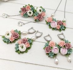 three necklaces with flowers and pearls are on the table next to each other,