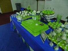 a blue table topped with green and white cakes