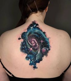 the back of a woman's shoulder with space and stars on it