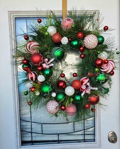 a christmas wreath hanging on the front door