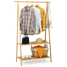 a clothes rack with two shirts and shoes on the top shelf, next to an umbrella