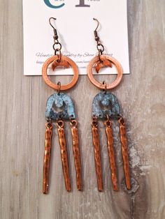 These boho style earrings feature copper hoops .75" in diameter with patina copper and wavy copper bar dangles.   These earrings measure 4" in length. They will ship in a gift box or bag via USPS with tracking info provided. Copper Dangle Earrings With Patina, Copper Dangle Jewelry With Patina, Artsy Copper Drop Earrings, Artisan Copper Dangle Hoop Earrings, Hand Forged Copper Hoop Earrings With Dangle, Hand Forged Copper Dangle Hoop Earrings, Artsy Nickel-free Copper Earrings, Artisan Nickel Free Copper Hoop Earrings, Rustic Copper Earrings With Ear Wire