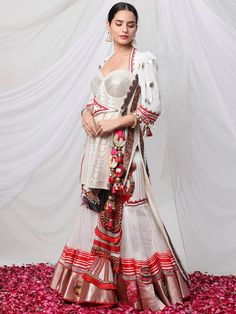 Garad Angrakha Lehenga - Inspired by gauri(durga), this lehanga set brings elements of akalbodhan, translating to the untimely awakening of Durga. The set features a gota bralette, an angrakha jacket and a full-pleated skirt, making it a perfect royal garment for your special occasions. Traditional Palazzo Set For Navratri With Traditional Drape, Bollywood Style Traditional Drape Palazzo Set For Navratri, Bollywood Style Palazzo Set For Navratri, Navratri Bollywood Style Traditional Palazzo Set, Navratri Palazzo Set With Sheer Dupatta, Traditional Transitional Palazzo Set, Designer Wear Palazzo Set For Navratri With Pallu, Eid Sharara With Tilla Detailing, Eid Semi-stitched Tilla Sharara