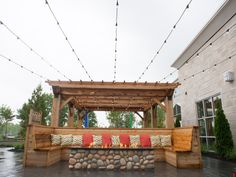 an outdoor seating area with fire pit and string lights