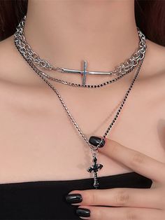 This necklace features a multi-layer design that exudes a sense of sophisticated style. The overlapping chains create a unique and eye-catching look. Adorned with a black rhinestone-embellished cross pendant, it adds a touch of edgy coolness to any outfit.  Please note that the price includes only one necklace. Trendy Cross Chain Necklace, Party Cross Necklace With Clavicle Chain, Metal Cross Necklace With Chain Pendant, Metal Cross Necklace With Chain, Trendy Black Cross Jewelry, Metal Cross Pendant Necklace With Chain, Black Cross Necklace With Chain, Silver Cross Choker For Party, Black Cross Pendant Chain Necklace