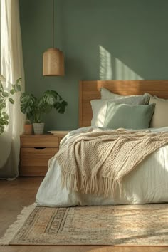 a bedroom with green walls and white bedding in the corner, along with potted plants