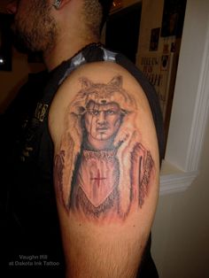 a man with a wolf tattoo on his arm