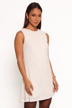 DETAILS   Transform your nights out with our stunning Sequin Mini Dress. This isn't just a dress; it's your ticket to turning heads, feeling fabulous, and making memories in style.    mini length  round neckline  sleeveless  open back with tie close feature  invisible side zip  shirred back panel   sequin design  lined   material - 100% polyester / lining - 95% polyester, 5% spandex    SIZING     studio model is 5' 8" and wears a Size XS    model stats: bust - 31", waist - 24", hips - 35" Sequin Design, Sequin Mini, Sequin Mini Dress, Making Memories, Cream Dress, Round Neckline, Side Zip, Open Back, Night Out