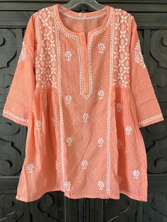 Coral Pure Cotton Lucknowi Kurti Short Top Spring Anarkali Long Sleeve Blouse, Anarkali Tunic With Resham Embroidery For Summer, Summer Anarkali Tunic With Resham Embroidery, Festive Anarkali Tops For Spring, Straight Kurta Tops For Navratri Festive, Traditional Navratri Tunic With Printed Motifs, Festive Straight Kurta Tops With Cutdana, Spring Anarkali Top With Long Sleeves, Spring Anarkali Long Sleeve Tops