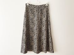 "Vintage Animal print midi skirt, a-line women's skirt, lightweight leopard print skirt, beige black cheetah print women skirt, gift idea for her Measurements: Waist: 29.5\" Hips: 41\" Length: 33\" Please check measurements to insure a proper fit. Remember to allow yourself some extra room for movement. You can compare these with something from your closet that fits you well. Condition: Good vintage condition SHIPPING * I ship worldwide via Priority mail (Latvijas Pasts) from Latvia (EU). * I ship from Europe, so please allow 2 to 4 weeks for the package to arrive if you live overseas. * Europe 5 - 10 business days. Go back to my shop: YourEclecticStreet.etsy.com P.S. why buy Vintage? - Vintage is Unique! - Vintage is Eco Friendly! - Vintage is Inspirational! - Vintage is History! - Vintag Fitted Long Skirt In Leopard Print, Leopard Print Long Skirt For Spring, Long Leopard Print Skirt For Spring, Spring Leopard Print Midi Skirt, Elegant Leopard Print Lined Skirt, Chic Lined Leopard Print Skirt, Leopard Print Flowy Long Skirt, Chic Leopard Print Lined Skirt, Chic Leopard Print Skirt