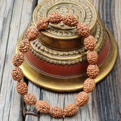 📿Our Four Mukhi Bracelet is handcrafted with Natural 4 Mukhi (Four-Faced) Rudraksha Beads. This Bracelet is essentially for those who seek knowledge, comprehending the essence behind the creation and become more creative. Like the four-faced Lord Brahma, the wearer gains knowledge from all the four cardinal directions. It is suitable for all 4 stages of human life. They are Brahmacharya, Grihastha, Vanaprastha and Sanyasa. The new age contemporary lifestyles require continuous assimilation of k Traditional 108 Beads Bracelet For Festivals, Traditional Bracelets With 108 Beads For Festivals, Traditional Brown Bracelet For Rituals, Traditional Hand-strung Wristband As Gift, Handmade Bracelets For Puja And Festivals, Traditional Hand-strung Bracelets For Meditation, Traditional Hand-wrapped Bracelets For Meditation, Traditional Bracelets With 8mm Beads For Festivals, Traditional 8mm Beaded Bracelets For Festivals