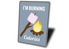 a sign that says i'm burning calories with a campfire on it