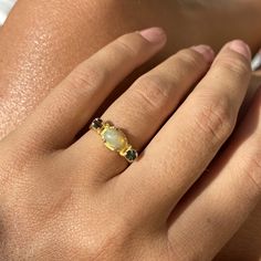 Choose between these gorgeous polished Ethiopian opal rings with amazing sparkles set in sterling silver and then gold plated. The ring has a little different faceted tourmaline on each side of the main stone. Choose between: Blue and yellow- N 1/2 (UK/AU size ring) 6 3/4 (US size) Green and brown- L 1/2 (UK/AU size ring) 5 7/8 (US size) Blue and pink- N 1/2 (UK/AU size ring) 6 3/4 (US size) Pink and brown- M 1/2 (UK/AU size ring) 6 1/4 (US size) This ring would make the most perfect bridesmaid' Gold Opal Multi-stone Ring, Gold Opal Ring With Birthstone, Gold Opal Birthstone Ring, Yellow Gold Ring With Ethiopian Opal And Birthstone, Yellow Gold Ethiopian Opal Ring With Birthstone, Yellow Gold Ethiopian Opal Birthstone Ring, Gold Ethiopian Opal Ring Fine Jewelry, Gift Yellow Gold Multi-stone Opal Ring, Yellow Gold Opal Ring With Gemstone Accents As Gift