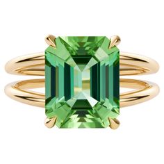 With a design that simply cannot go unnoticed, our Lagoon Tourmaline Cocktail Ring is where a 5-carat neon green tourmaline finds its soulmate in in solid yellow gold. Part of our signature cocktail collection, this ring hugs the finger it adorns with a bold two band shape culminating in the central stark tourmaline – coloured to reflect the mesmerizing Maldives ocean. Materials: - 14k solid gold - Gemstone: natural lagoon green, neon Tourmaline - certified - AAAA Heirloom Quality Gemstone - Weight of gemstone: 5.30 carat - Sustainably earth-mined - Accompanied with an independent certification of authenticity - Delivered in luxury packaging - This piece has been certified in accordance with the - - Hallmarking Act 1973 - Lifetime guarantee This piece comes with a formal and independent ce Elegant Emerald-cut Tourmaline Ring, Yellow Gold Tourmaline Emerald-cut Ring, Luxury Lime Green Gemstone Ring, Luxury Polished Tourmaline Rings, Luxury Green Tourmaline Jewelry, Luxury Packaging, Modern Ring, Signature Cocktail, Jewelry Lookbook