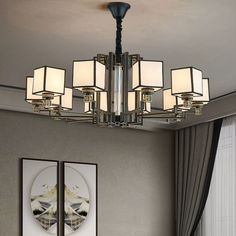 a chandelier hanging from the ceiling in a living room