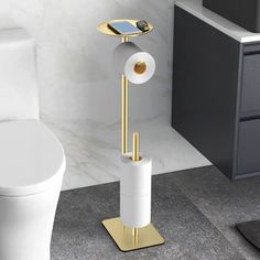 a bathroom with a toilet, sink and phone holder