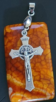 "This vintage exotic stone and silver crucifix pendant is definitely a statement piece. The Crucifix features St Benedict on the back.  Snakeskin agate is known for energizing the root, solar plexus and crown chakras, It can be an excellent tool in helping with emotional traumas. It promotes strength and perseverance during times of turmoil.   The St. Benedict medal when blessed offers exceptional protection from evil and is one of the 3 sacramental medals of the Catholic Church. The crucifix is Gift Crucifix Necklace With Large Pendant, Large Crucifix Pendant Necklace As A Gift, Handmade Spiritual Cross Pendant Jewelry, Crucifix Necklace With Large Pendant As Gift, Spiritual Handmade Cross Pendant Jewelry, Spiritual Crucifix Jewelry With Large Pendant, Spiritual Jewelry With Large Crucifix Pendant, Brown Crucifix Jewelry Gift, Brown Crucifix Jewelry For Gifts