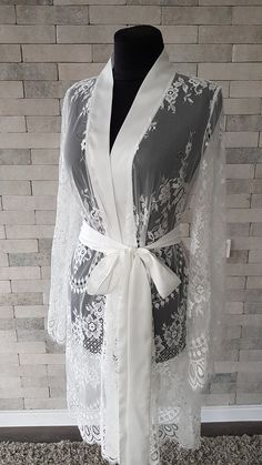 Off-white luxurious wedding robe, to add a perfect touch to your perfect and unique day. Only high quality fabrics and high finishing used for making the robe as neat as it can be. Please find the wedding robes collection here https://www.etsy.com/shop/LidiasBoutiqueDesign?ref=seller-platform-mcnav&section_id=25023222. For wedding dresses, please access https://www.etsy.com/shop/LidiasBoutiqueDesign?ref=seller-platform-mcnav§ion_id=23157290. For wedding tops and boleros, please access https: Elegant Wrap Kimono For Wedding Night, Elegant Lace Gown For Wedding Night, Long Lace Robe For Wedding Night, Feminine Lace Wedding Robe, Elegant Bridesmaid Lace Dress, Elegant Wedding Gown With Delicate Lace, Long Sleeve Delicate Lace Dress For Wedding Night, Elegant Open Front Kimono For Wedding, White Lace Nightgown For Wedding