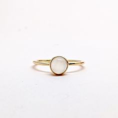 Natural Fine Moonstone Ring. Round Stone Ring. Semi Precious Gemstone Ring in 14k SOLID GOLD For Her from our Capsule Jewelry Collection. Round Moonstone Gemstones are set in Bezel Setting in our Factory. Gold Ring AA+ Quality. Perfect Gift For Everyday or June Birthstone Gift for Your Loved Ones. ►  DIMENSIONS : ◆ Gemstone : Moonstone 0.35 Cts                     ◆ Stone size : 6 mm                                           ◆ Shank Width : 1 mm      ◆  Material :  14k Yellow Gold          Made White 14k Gold Jewelry With Round Stone, Gold Stackable Moonstone Ring, Round Shape, Dainty Round Jewelry With Smooth Bezel, Minimalist Opal Ring With Bezel Setting As Gift, Minimalist Jewelry With Smooth Bezel For Gifts, Minimalist Jewelry With Smooth Bezel As Gift, Minimalist Jewelry With Smooth Bezel Gift, 14k Gold Filled Gemstone Ring, Fine Jewelry 14k Gold Open Moonstone Ring