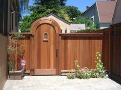 a wooden gate in front of a house