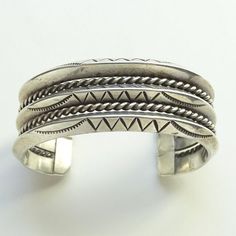 This is a Vintage 84 Gram Native American 3 Row Carinated Cuff Bracelet Stamp Decorated. This fabulous triple carinated sterling silver (tested) cuff bracelet is heavy, and weighs 84.2 grams. Each carinated row is stamp decorated and separated by rope twist wire. The terminal ends are capped. The bracelet measures 5 1/2 inches, plus a 1 1/4 inch gap, for a total of 6 3/4 inches. The width measures 1 inch. The bracelet is a little too big for my 6 1/4 inch wrist. There is NO flexibility for size Classic Stamped Cuff Bracelet, Classic Stamped Cuff Bracelets, Classic Cuff Bracelets For Wedding, Heirloom Adjustable Cuff Bangle Bracelet, Classic Handmade Cuff Bracelets, Classic Cuff Bangle, Classic Handmade Cuff Bracelet, Classic Cuff Bangle For Anniversary, Classic Engraved Cuff Bracelets