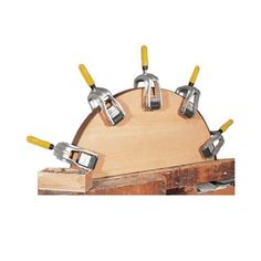 a bunch of tools that are on top of a wooden board with some yellow handles