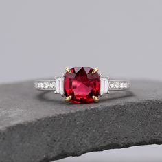 ABOUT THIS RING Cushion Cut Lab Created Ruby Two-Tone Ring Solid Gold Ring Engagement Ring For Women, Red Gemstone Ring, Anniversary Gift, Handmade Ring -------------------------------------------------------- 「Product Summary」 ◆ Metal Material: Gold / Platinum ◆ Center Stone Stone: 2.0ct Lab Created Ruby Cut: 7*7mm Cushion Cut ◆ Side Stone Stone: Moissanite Carat Weight: About 0.28ct ◆ Band width: 1.6mm ◆ More Information *Can be custom item *Rush orders are accepted *2~3 weeks for order length Red Sapphire Ring Fine Jewelry Birthstone, Fine Jewelry Rings With Lab-created Ruby And Accent Stones, Classic Red Three Stone Diamond Ring, Fine Jewelry Red Diamond Three Stone Ring, Red Three-stone Diamond Ring For Anniversary, Red Three Stone Diamond Ring For Promise, Red Three-stone Diamond Promise Ring, Red Three Stone Diamond Promise Ring, Fine Jewelry Red Ruby Ring