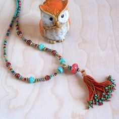 Another piece from the Turquoise Coral Collection comes this amazing, long beaded tassel necklace.  Wire wrapped beaded tassel is the focal point for this beautiful piece. Mixed matching and complementary colors of turquoise green and terracotta red/orange coral colors. Metal finish available in Gold or Vintage Bronze. Choose your perfect length at checkout. Want more of the look? Check out all of the matching earrings and necklaces in the shop by searching Turquoise Coral Collection, or have a custom piece made. This necklace comes gift wrapped/boxed at no extra charge. Sending to a friend? I'll even write on the tag for you. Ships Free to the U.S. and Puerto Rico. Discounted International shipping. Keep the Beach in Your Life! Adjustable Bohemian Tassel Necklace With Colorful Beads, Bohemian Turquoise Necklace With Colorful Beads For Gift, Bohemian Long Tassel Necklace As A Gift, Bohemian Long Tassel Necklace, Bohemian Tassel Necklace With Colorful Round Beads, Bohemian Tassel Necklace With Colorful Beads, Bohemian Tassel Necklace With Round Beads For Beach, Bohemian Multicolor Tassel Necklace With Colorful Beads, Turquoise Jewelry With Tassels And Round Beads