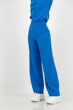 Patent Pending These high-waisted, wide-leg trousers redefine versatility, seamlessly transitioning from scrubs to office wear and smart casual effortlessly. The minimalist and elegant design adds a touch of sophistication to any ensemble. The high-waisted fit and wide-leg silhouette create a flattering and timeless lo Ciel Blue Scrubs, Stylish Scrubs Nurses, Comfy Work Pants, High Waist Solid Pants For Office, Modern High Waist Wide Leg Office Pants, Solid Wide Leg Office Pants, Wide Leg Office Pants In Solid Color, Solid Wide Leg Pants For Work, Modern Wide Leg Pantsuit For Office