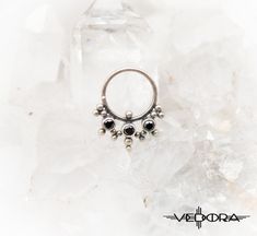 Adorn yourself with Vesta body jewelry. Hand-crafted 9.25 sterling silver with colored crystal inlay, wear it in your septum, side nostril, or wear it as an earring. Please note all nose jewelry is non-refundable. ▪ 𝐃𝐈𝐌𝐄𝐍𝐒𝐈𝐎𝐍𝐒 ▪ * 12 mm x 15 mm * 18 Gauge * 8 mm Inner Diameter ▪ 𝐏𝐀𝐂𝐊𝐀𝐆𝐄 𝐈𝐍𝐂𝐋𝐔𝐃𝐄𝐒 ▪ * One nose jewelry, as pictured. ▪ 𝐉𝐄𝐖𝐄𝐋𝐑𝐘 ▪ * https://www.etsy.com/shop/vedora ▪ 𝐃𝐈𝐒𝐂𝐎𝐔𝐍𝐓 𝐂𝐎𝐃𝐄𝐒 𝐀𝐍𝐃 𝐍𝐄𝐖 𝐃𝐄𝐒𝐈𝐆𝐍 𝐑𝐄𝐋𝐄𝐀𝐒𝐄𝐒 ▪ * https://www Nickel Free Silver Piercings, Nickel Free Round Silver Piercings, Nickel-free Round Silver Piercings, Spiritual Silver Body Jewelry For Gift, Unique Sterling Silver Body Jewelry For Gifts, Unique Sterling Silver Body Jewelry Gift, Sterling Silver Birthstone Piercings, Nickel-free Metal Body Jewelry, Internally Threaded White Gold Septum Ring In Sterling Silver