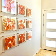 the wall is decorated with orange and white paintings on glass blocks, along with a wooden floor