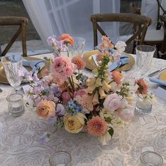 an arrangement of flowers on a table at a wedding reception