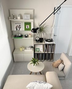 an overhead view of a living room with a couch, coffee table and bookshelf