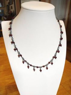 Beautiful handmade blackened sterling silver necklace with intense red Garnet Facetted beads, 4 mm. 17 inch long. I can make it a little longer if you like. I can also make this necklace with other beads you may like. Price may vary. Makes a great gift. Red Beaded Sterling Silver Necklace, Victorian Garnet Necklace For Gift, Red Garnet Gemstone Beaded Necklace, Elegant Red Garnet Beaded Necklaces, Red Garnet Round Bead Necklaces, Sterling Silver Wire Wrap, Oxidized Sterling Silver, Red Garnet, Silver Wire