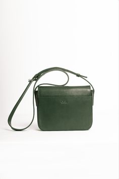 Smooth leather crossbody bag, lined with cotton fabric. It features a front flap with magnetic snap closure it has a roomy compartment, a slim interior pocket, and one exterior pocket.The strap is adjustable. Classic Everyday Shoulder Flap Bag, Classic Everyday Crossbody Saddle Bag, Classic Green Flap Bag With Adjustable Strap, Classic Green Shoulder Bag With Detachable Strap, Classic Green Shoulder Bag With Magnetic Closure, Classic Crossbody Shoulder Bag With Adjustable Strap, Classic Shoulder Flap Bag With Adjustable Strap, Everyday Green Leather Flap Bag, Green Crossbody Saddle Bag With Removable Pouch