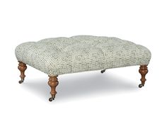 the foot stool is made from wood and has an upholstered pattern on it