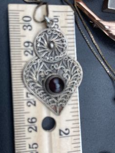 Beautiful antique vintage filigree Pendant sterling silver 925 Garnet Gemstone ornate design heart like Necklace Chain scrolls. Just over 24 inch long box chain. Vintage Filigree Heart Pendant Jewelry, Antique Heart Jewelry With Intricate Design, Antique Heart-shaped Jewelry With Intricate Design, Victorian Heart-shaped Filigree Jewelry, Ornate Heart-shaped Vintage Charm Jewelry, Victorian Heart Pendant Jewelry With Intricate Design, Victorian Heart Pendant With Intricate Design, Vintage Heart-shaped Filigree Necklaces, Vintage Heart Filigree Necklaces