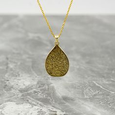 Crafted as a timeless piece of art, the Ayatul Kursi Islamic Necklace transcends mere adornment, embodying elegance and spirituality. This exquisite necklace features intricate Arabic calligraphy, delicately engraved to showcase the revered verses from the Quran. Made with 925 sterling silver and luxuriously gold plated, this pendant exudes a sense of divine beauty and grace. A perfect gift for the modern Muslim woman, this dainty necklace is a symbolic expression of faith and devotion. Whether Spiritual Gold Teardrop Pendant Necklace, Spiritual Gold Teardrop Necklace, Gold Teardrop Pendant Necklace As Gift, Traditional Teardrop Necklace For Gift, Elegant Brass Drop Necklace For Gift, Elegant Engraved Necklace With Rectangular Pendant, Brass Pendant Drop Necklace As A Gift, Traditional Teardrop Large Pendant Necklace, Spiritual Teardrop Brass Necklaces