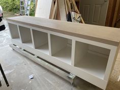 an unfinished entertainment center being built in a garage