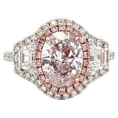 GIA Certified engagement ring featuring one Very Light Pink Oval weighing 2 Carats SI1, flanked with two Trapezoids, 0.59 Carats D VS, 22 Fancy Light Pink diamonds, 0.11 Carats VS, and 53 round brilliants weighing 0.51 carats, D-E VS, in Platinum and 18 Karat Rose Gold. Pink Diamond Halo Ring, Dani Martin, Famous Engagement Rings, Blue Diamond Engagement Ring, Oval Halo Engagement Ring, Yellow Diamonds Engagement, Edwardian Engagement Ring, Fancy Light, Pink Diamond Ring