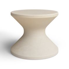 a white table with a round base on it's side, against a white background